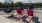 a couple of red chairs on a deck overlooking a city