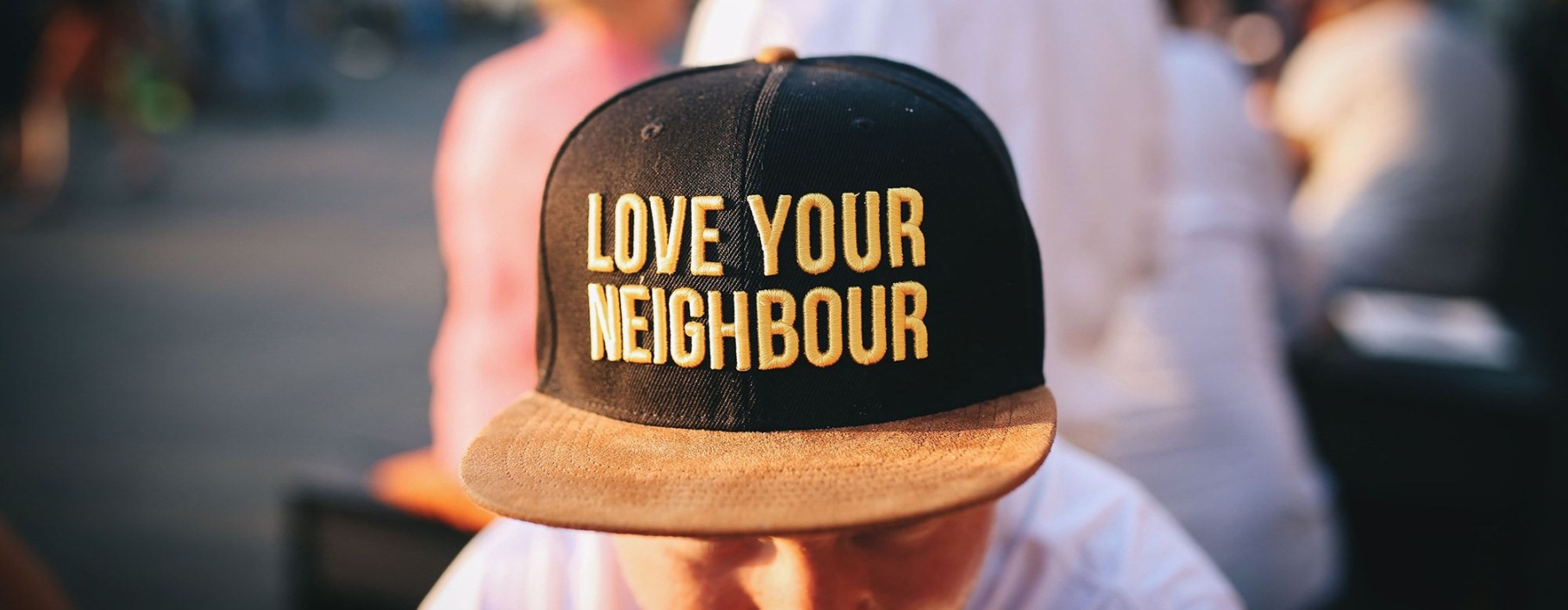 a man wearing a positive message on his hat